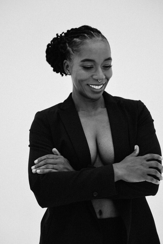 Dr. Hope L. Hayes laughing with her arms crossed in a relaxed and confident pose
