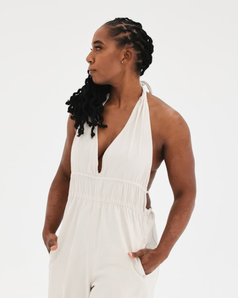 Dr. Hope L. Hayes looking to the side with hands in her pockets in a confident, professional stance
